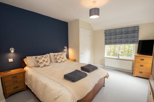 a bedroom with a bed with two towels on it at Sherwood in Birdham