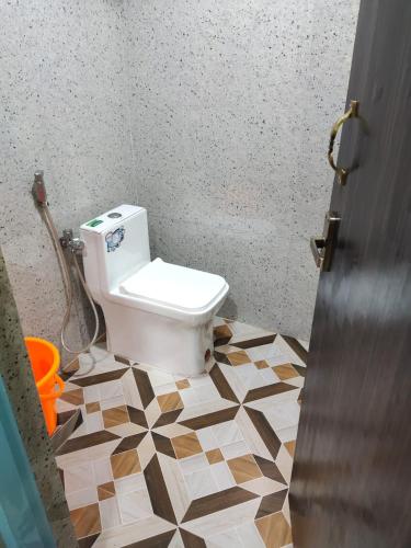 a bathroom with a toilet in a room at Chakravarthy Holidays in Kanchipuram