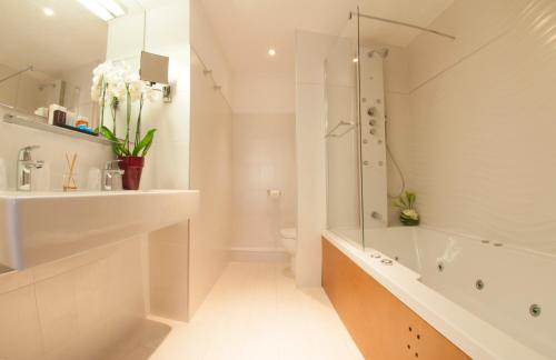 a bathroom with a shower and a toilet and a sink at Hôtel Montaigne & Spa - Cannes Centre in Cannes