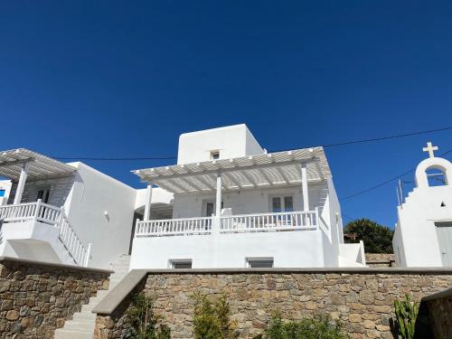 a white church with a cross on a building at Sofos Suites Mykonos in Mýkonos City