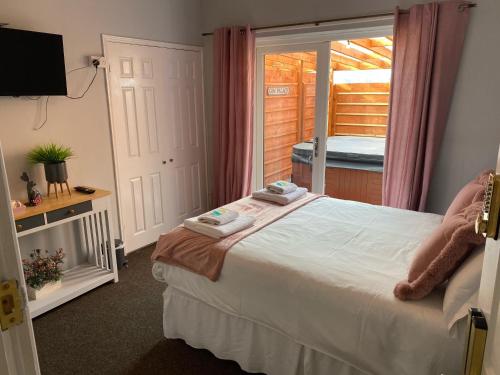 a bedroom with a bed and a window with a porch at The Mayfair Lodge & Family Suite in Hartlepool