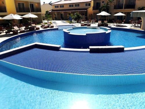 Kolam renang di atau di dekat Solar Água Flats de Frente para Piscina