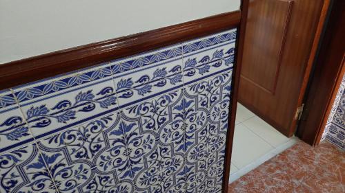 a staircase with a blue and white pattern on it at Enjoy Lisbon Cascais Sintra 1200 metres to metro blue line Sintra Rail line Free Parking in Amadora
