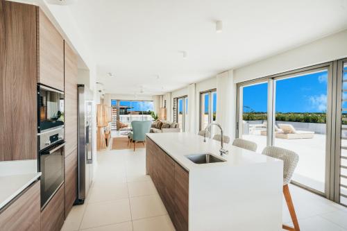 a kitchen with a view of a living room at Domaine de Grand Baie in Grand Baie