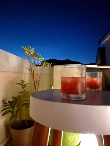 a drink in a glass sitting on top of a table at Carambola Résidence, Ocean View in Cul de Sac