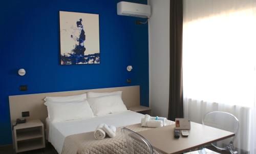 Posteľ alebo postele v izbe v ubytovaní Hotel Palazzo Caveja
