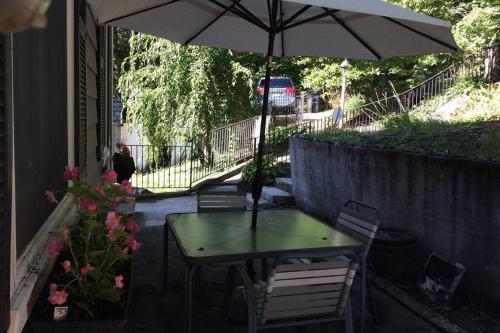 a table and chairs with an umbrella on a patio at Large family house on the lake in Hewitt