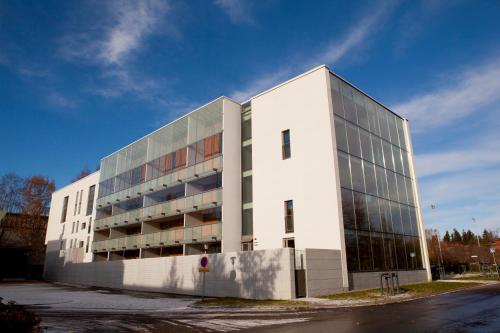 a large white building with a lot of windows at Aalto Inn in Espoo