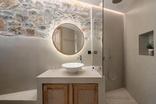 a bathroom with a sink and a mirror at The Authentic Village Boutique Hotel in Khóra Sfakíon