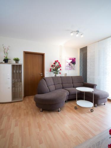 uma sala de estar com um sofá e uma mesa em Ferienwohnung Fernblick em Saarbrücken