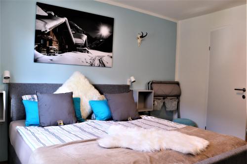 a bedroom with a bed with a white blanket on it at Apartments Zwigl in Flattach