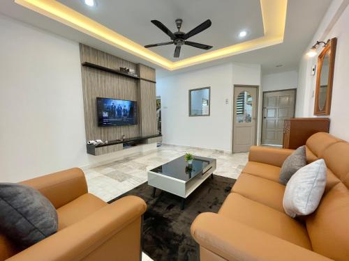 a living room with a couch and a tv at Century Suria Aparment Langkawi by Zervin in Kuah