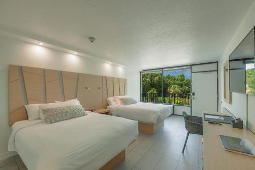 מיטה או מיטות בחדר ב-Casey Key Resorts - Mainland