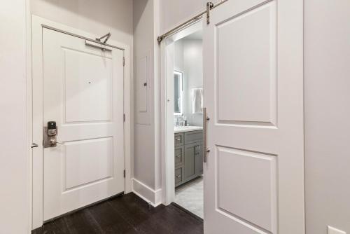 a white door in a bathroom with a sink at The Sazerac in New Orleans