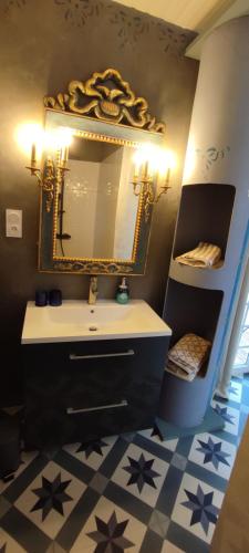 a bathroom with a sink and a mirror at Domaine Le Lanis Chambre d'hôtes avec spa sur réservation in Saint-Girons