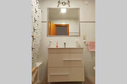 a white bathroom with a sink and a mirror at Villa rústica privada con gran chalet y piscina in Elche