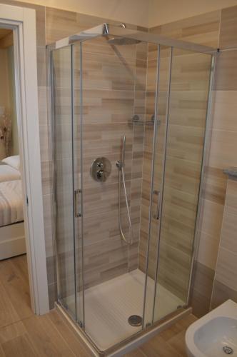 a shower with a glass door in a bathroom at B&B La Luce Verde in Saluzzo