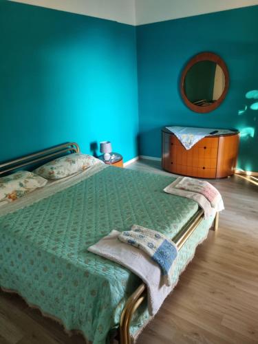 a bedroom with a bed with a dresser and a mirror at Agriturismo Pietro Falcone in Celico