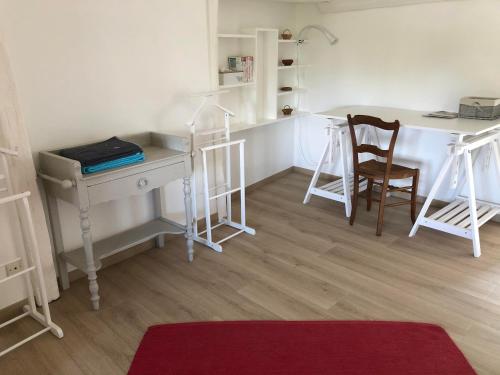 a room with a desk and two chairs and a table at Le logis du Vassal in Laval
