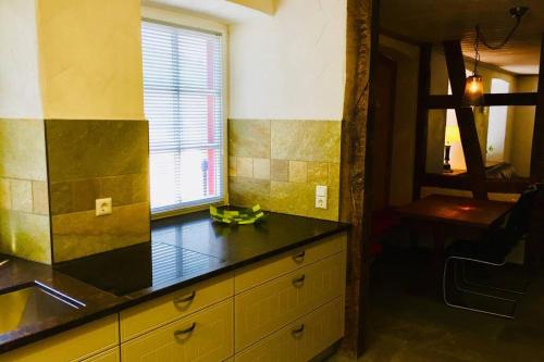 a kitchen with a counter and a sink and a window at Apartment Omega in Creglingen