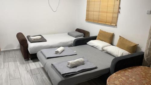 a room with three beds with towels on them at 2לופית in Eilat