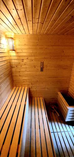 an inside of a wooden sauna with a wooden at Hotel Farma Vysoká in Chrastava