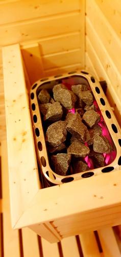 a crate full of rocks in a wooden box at Hotel Farma Vysoká in Chrastava