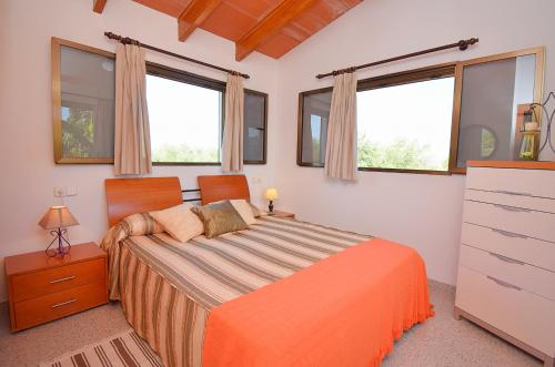 a bedroom with a bed in a room with windows at 032 Finca Son Estrella ETV9306 by Mallorca Charme in Muro