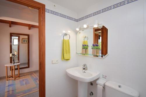 a white bathroom with a sink and a mirror at 032 Finca Son Estrella ETV9306 by Mallorca Charme in Muro