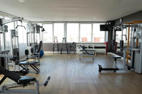 a gym with treadmills and machines in a room at Plaza São Rafael Hotel in Porto Alegre
