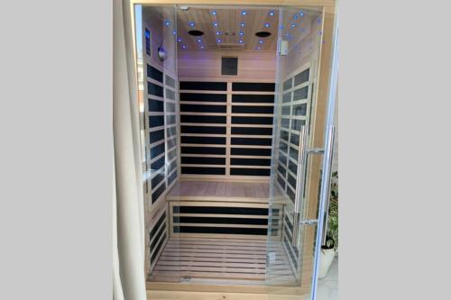 a walk in closet with a glass door at V' Appart Spa in Troyes