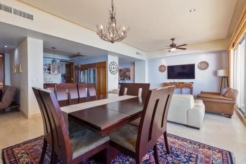 a dining room with a table and chairs and a couch at Encanto Living 1104 by Kivoya in Puerto Peñasco