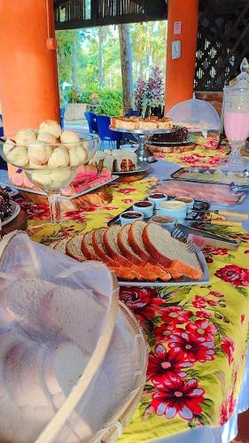 a table topped with plates of food on a table at Pousada e Restaurante Dona Siroba in Morretes