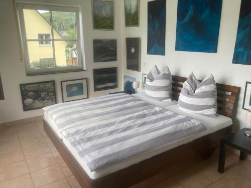 a bedroom with a large bed with pillows on it at Ferienwohnung Siegaue in Windeck