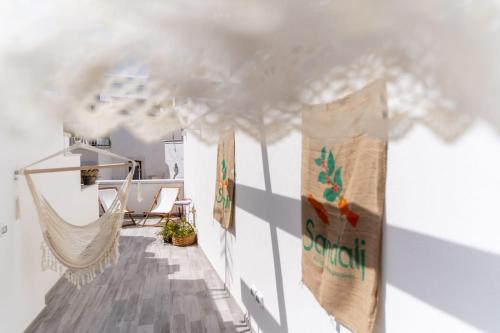 a room with a hammock and a cloud at La Casetta di Erasmina in Castellana Grotte