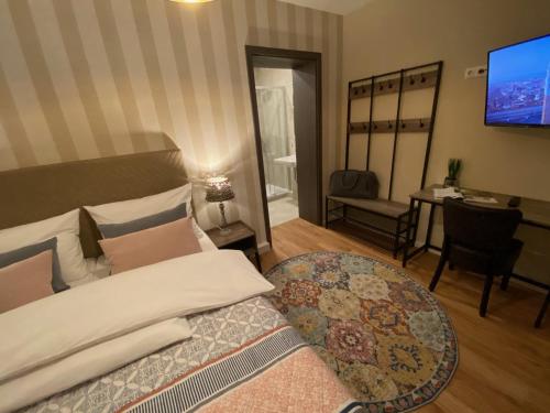 a bedroom with a bed and a table and a television at Hotel Tortuga & Tex-Mex Bar & Grill in Grafenwöhr