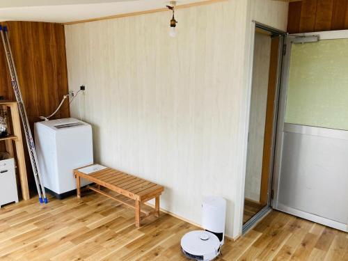 a room with a wooden bench and a refrigerator at Challenge kyoten YOKANA - Vacation STAY 63919v in Noma