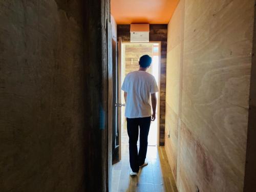 a man walking down a hallway at Challenge kyoten YOKANA - Vacation STAY 63919v in Noma