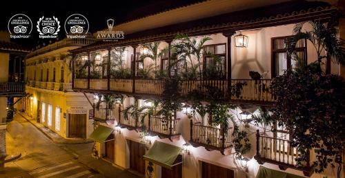 a building with potted plants on the side of it at Leones de Alba Hotel Boutique in Cartagena de Indias
