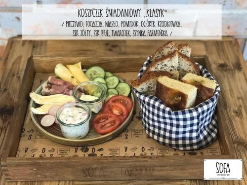 a tray of food with a plate of bread and vegetables at Aparthotel Zakątna B&B in Tarnów