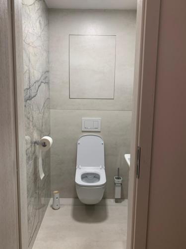 a bathroom with a toilet in a small room at ARMERIA 4/1 in Štrbské Pleso