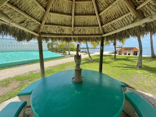 a blue table with a straw umbrella on a beach at Gulf View Waterfront Resort in Marathon