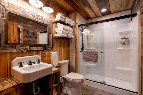 a bathroom with a shower and a sink and a toilet at Bunkhouse in West Yellowstone