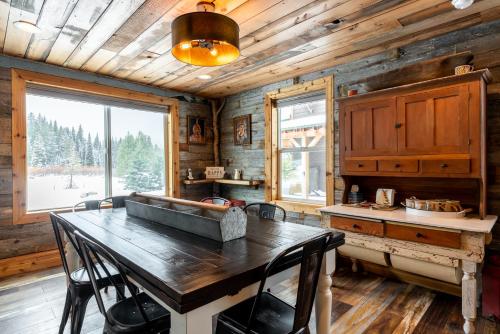 a kitchen with a large wooden table and a large window at Bunkhouse in West Yellowstone