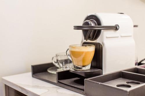 a coffee maker is making a cup of coffee at Hotel Theodore in Seattle