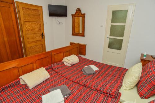 a bedroom with a bed with two towels on it at Familija 77 in Kikinda