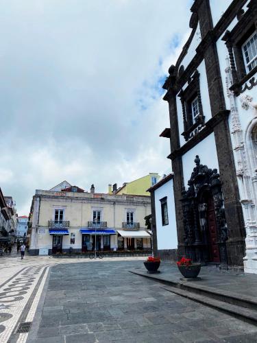 an empty street in a city with buildings at Karamba Azores AP central in Ponta Delgada