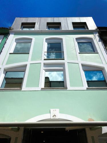 a blue building with windows on top of it at Karamba Azores AP central in Ponta Delgada