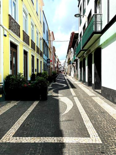 an empty street in a city with buildings at Karamba Azores AP central in Ponta Delgada