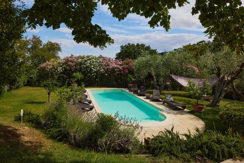 a swimming pool in a yard with chairs and trees at Villa Monacelli B&B in Fano